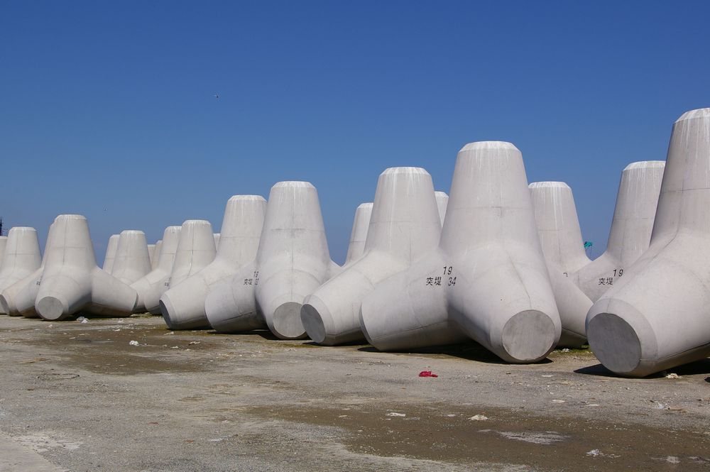 Fudo Tetra wave-dissipating concrete tetrapod blocks lining a coastal breakwater in Japan