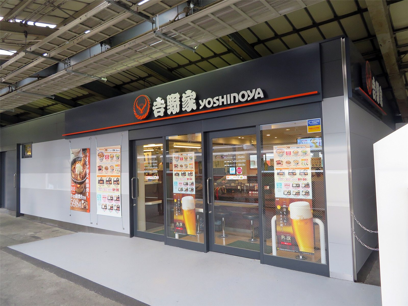 A Yoshinoya gyudon restaurant storefront with its orange signage
